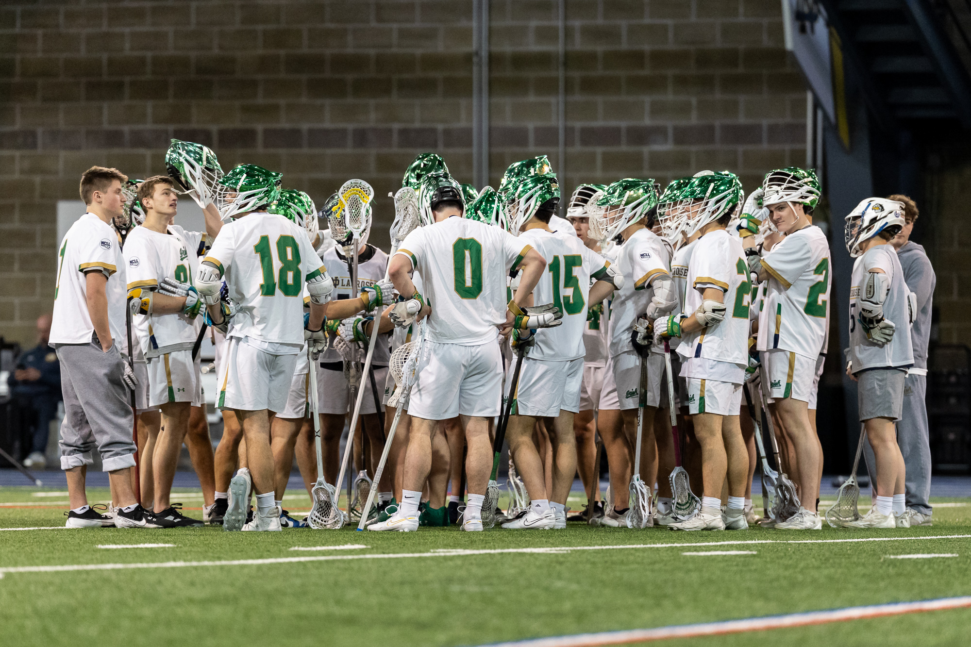 Notre Dame Men’s Club Lacrosse players huddle on the field